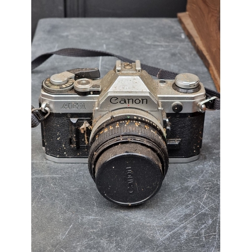 1593 - Cameras: a large collection of vintage cameras, lenses and related, to include binoculars.... 