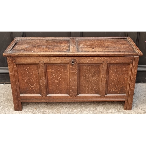 1111 - A late 17th century oak panelled coffer, 114cm wide, (wormed); together with another oak side cabine... 