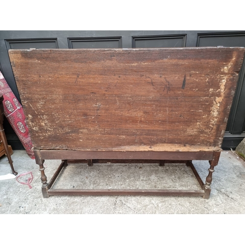 1111 - A late 17th century oak panelled coffer, 114cm wide, (wormed); together with another oak side cabine... 