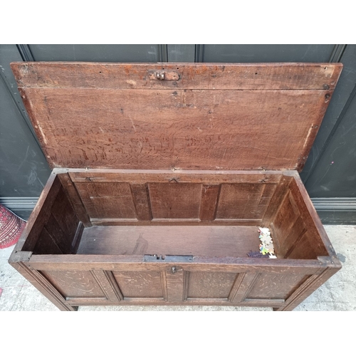 1111 - A late 17th century oak panelled coffer, 114cm wide, (wormed); together with another oak side cabine... 