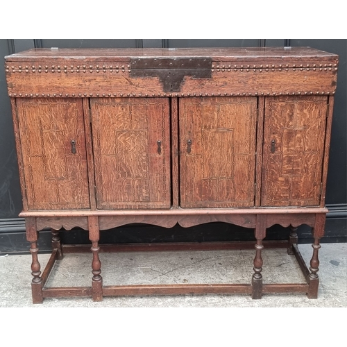 1111 - A late 17th century oak panelled coffer, 114cm wide, (wormed); together with another oak side cabine... 