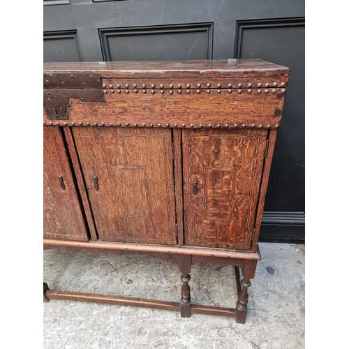 1111 - A late 17th century oak panelled coffer, 114cm wide, (wormed); together with another oak side cabine... 