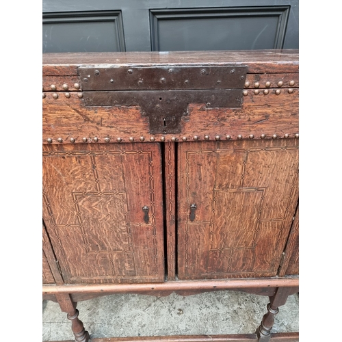 1111 - A late 17th century oak panelled coffer, 114cm wide, (wormed); together with another oak side cabine... 