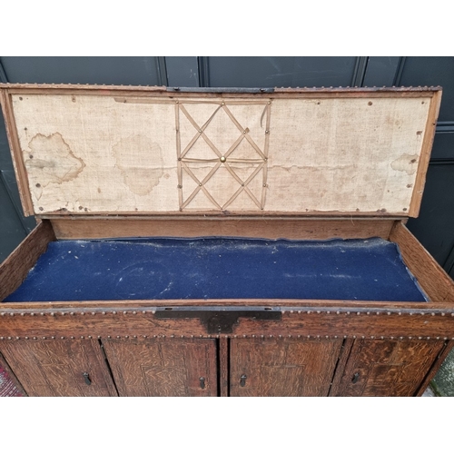 1111 - A late 17th century oak panelled coffer, 114cm wide, (wormed); together with another oak side cabine... 