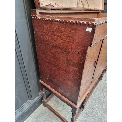 1111 - A late 17th century oak panelled coffer, 114cm wide, (wormed); together with another oak side cabine... 