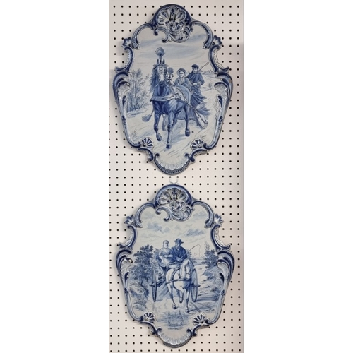 1674 - A pair of 19th century Dutch Delft wall plaques, each painted with a pony and trap, 55 x 40cm.... 