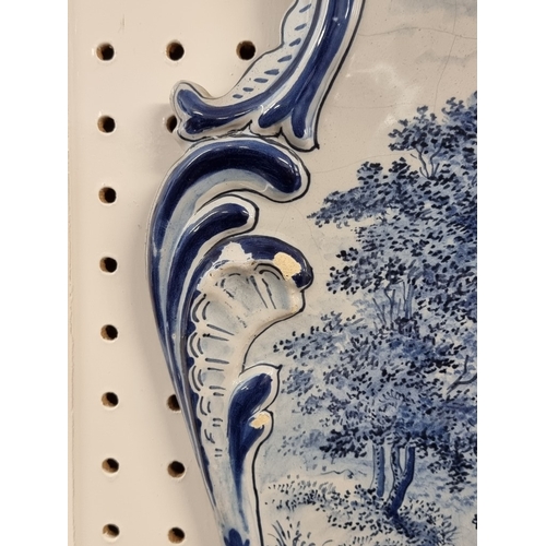 1674 - A pair of 19th century Dutch Delft wall plaques, each painted with a pony and trap, 55 x 40cm.... 