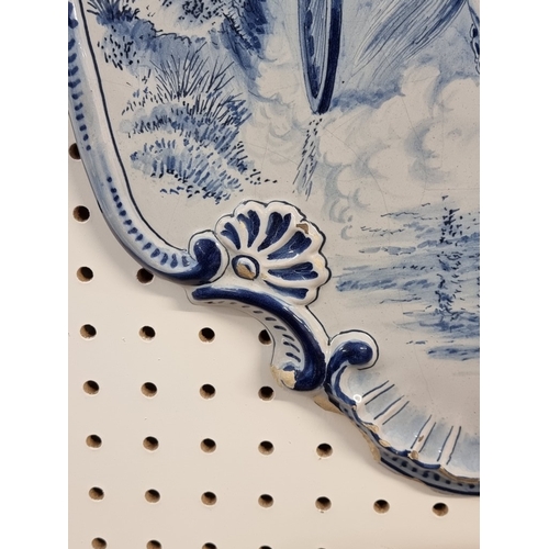 1674 - A pair of 19th century Dutch Delft wall plaques, each painted with a pony and trap, 55 x 40cm.... 