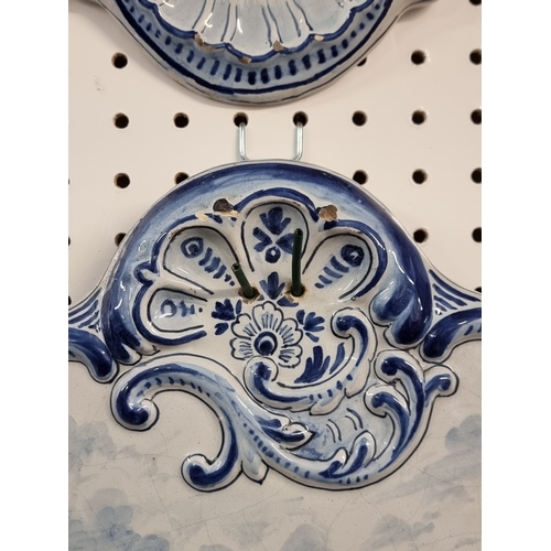 1674 - A pair of 19th century Dutch Delft wall plaques, each painted with a pony and trap, 55 x 40cm.... 