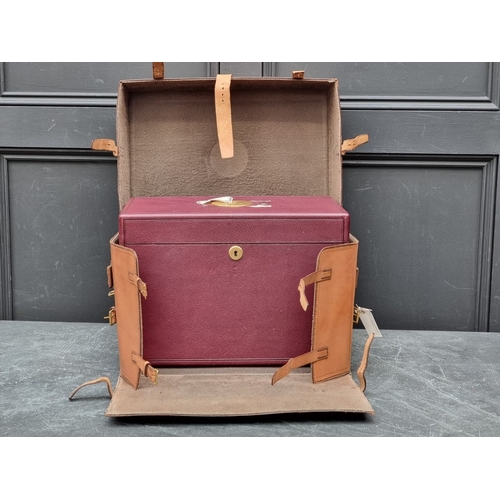 1677 - An interesting and impressive dark red leather jewellery chest, the hinged top applied with gilt bra... 