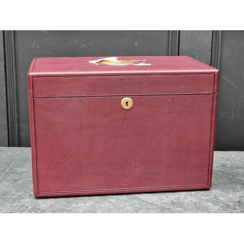 1677 - An interesting and impressive dark red leather jewellery chest, the hinged top applied with gilt bra... 