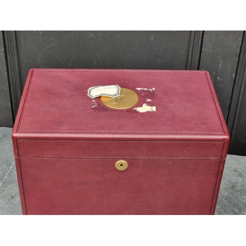 1677 - An interesting and impressive dark red leather jewellery chest, the hinged top applied with gilt bra... 