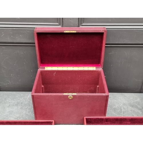 1677 - An interesting and impressive dark red leather jewellery chest, the hinged top applied with gilt bra... 