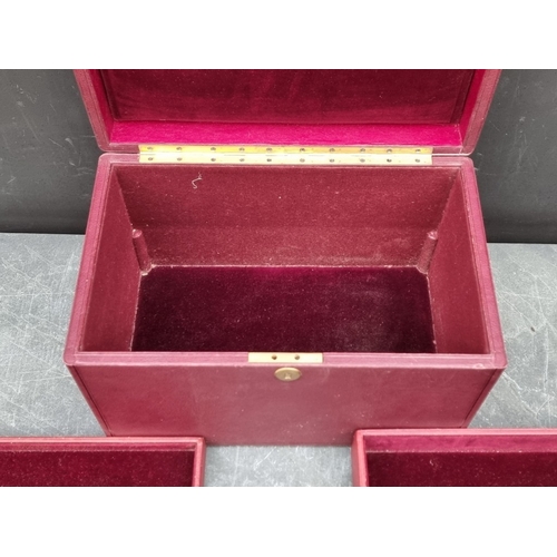 1677 - An interesting and impressive dark red leather jewellery chest, the hinged top applied with gilt bra... 