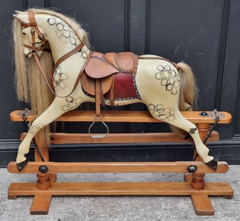 A large dapple grey rocking horse, 108cm high x 132cm long.