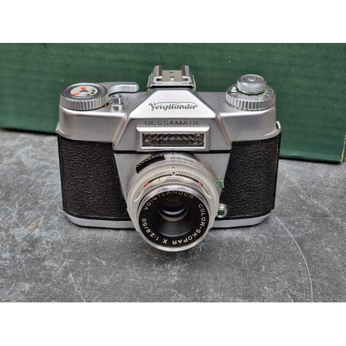 1597 - Cameras: a Voightlander 'Bessamatic', with Voightlander 'Color-Skopar X 1:2.8/50' lens, in leather c... 