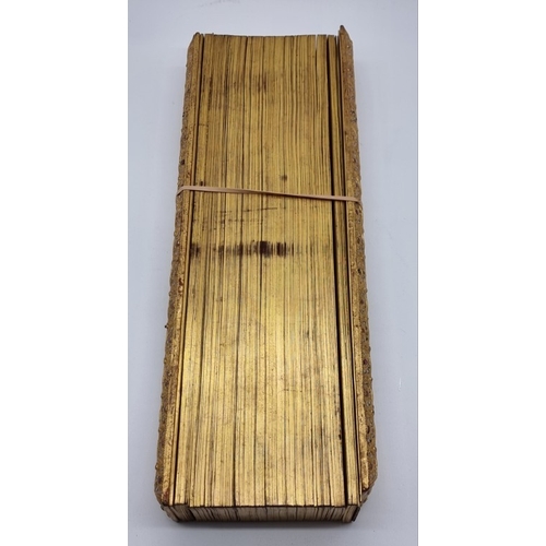 1664 - A Burmese Buddhist palm leaf manuscript or parabaik, with gilded edges and carved and 'gem set' bind... 