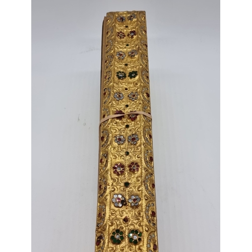 1664 - A Burmese Buddhist palm leaf manuscript or parabaik, with gilded edges and carved and 'gem set' bind... 