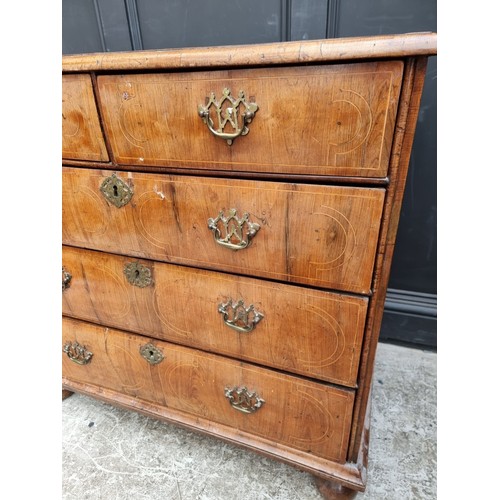 1025 - An 18th century walnut, line inlaid and crossbanded chest of drawers, on bun feet, 94.5cm wide.... 