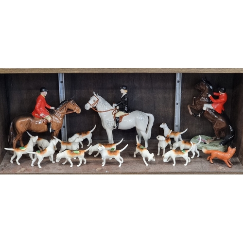 1374 - A group of Beswick hunting figures, comprising: 'Huntswoman', style two, on grey horse; 'Huntsman', ... 