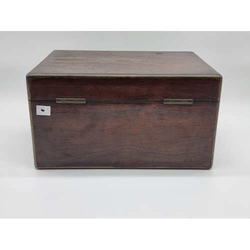 1449 - A Victorian rosewood and brass bound toilet box, the interior inscribed 'F. L. Hausburg, Manufacture... 