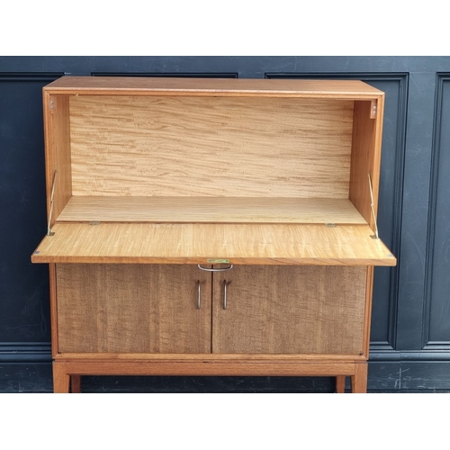 1018 - A mid-century Gordon Russell teak and walnut cocktail cabinet, 100.5cm wide.