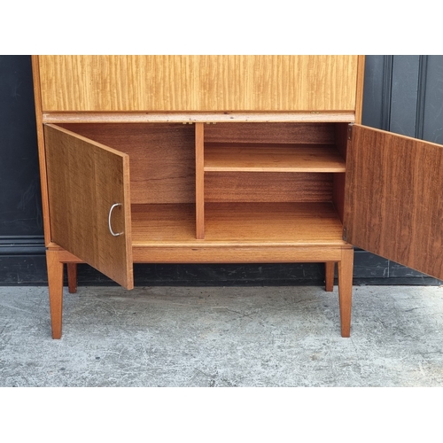 1018 - A mid-century Gordon Russell teak and walnut cocktail cabinet, 100.5cm wide.