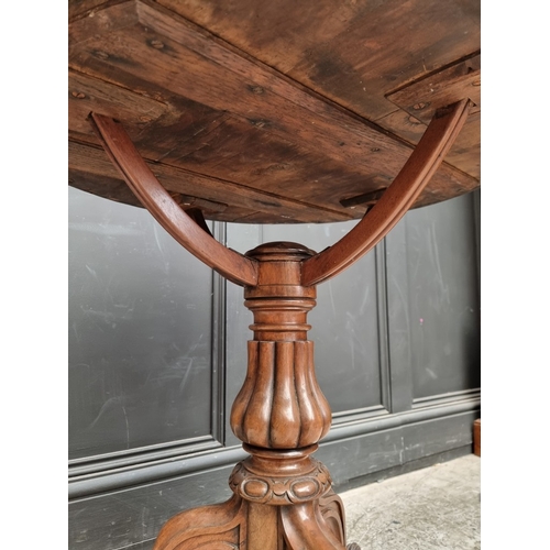 1022 - A Victorian walnut and specimen marble tripod occasional table, 67cm diameter.