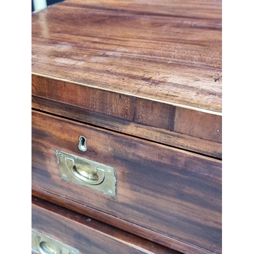 1039 - A 19th century mahogany and brass bound campaign style chest of drawers, in two parts, with counters... 
