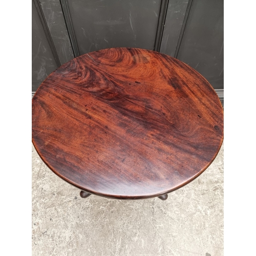 1052 - An early George III mahogany circular tilt-top tripod table, of good colour, the one-piece top with ... 