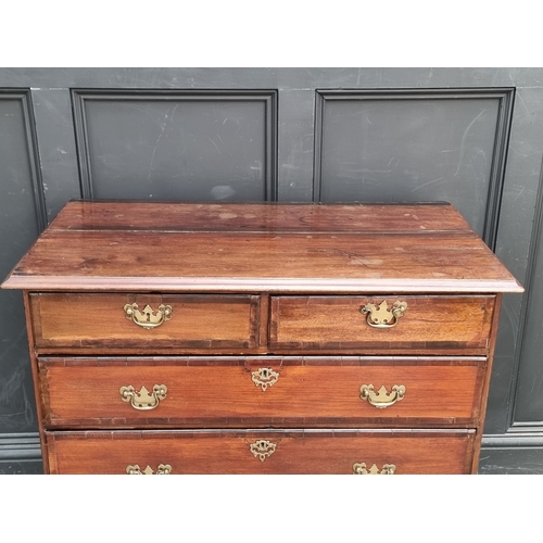 1007 - A George III mahogany and crossbanded chest of drawers, 97cm wide, (split to top).