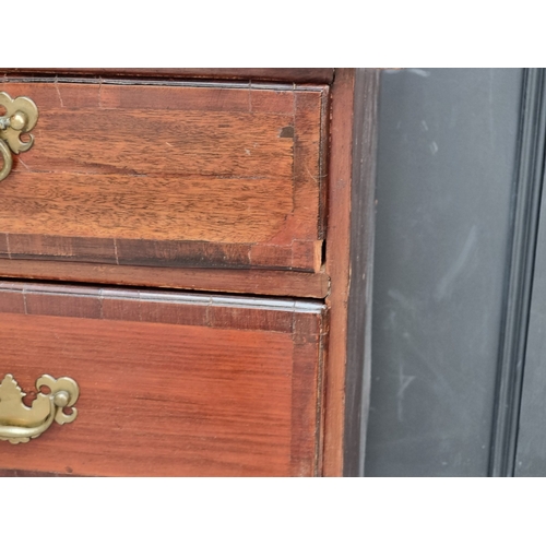 1007 - A George III mahogany and crossbanded chest of drawers, 97cm wide, (split to top).