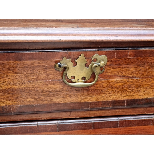 1007 - A George III mahogany and crossbanded chest of drawers, 97cm wide, (split to top).