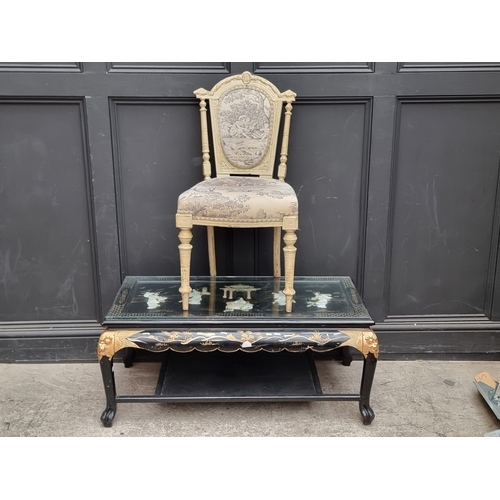 1015 - A Chinese black lacquered and relief decorated rectangular low occasional table, 105cm wide; togethe... 