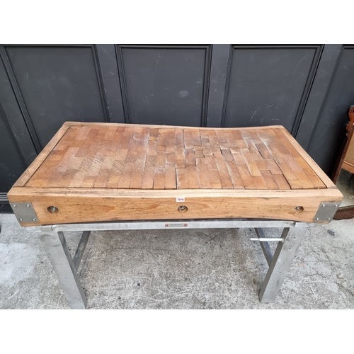 1016 - A large butchers' block, on stainless steel stand, the top 122 x 62.5cm.