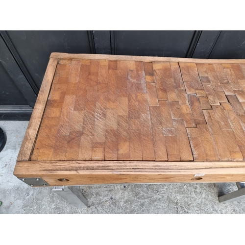 1016 - A large butchers' block, on stainless steel stand, the top 122 x 62.5cm.
