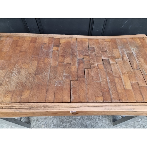 1016 - A large butchers' block, on stainless steel stand, the top 122 x 62.5cm.