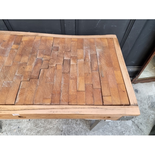 1016 - A large butchers' block, on stainless steel stand, the top 122 x 62.5cm.