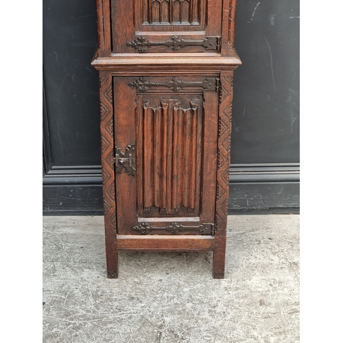 1026 - A 17th century style carved oak side cabinet,&nbsp;with&nbsp;tracery and&nbsp;linenfold panels, 132c... 