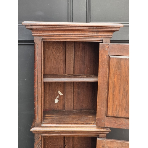 1026 - A 17th century style carved oak side cabinet,&nbsp;with&nbsp;tracery and&nbsp;linenfold panels, 132c... 