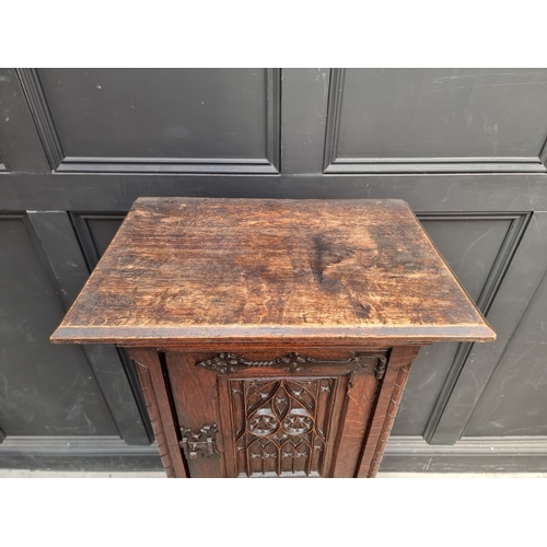 1026 - A 17th century style carved oak side cabinet,&nbsp;with&nbsp;tracery and&nbsp;linenfold panels, 132c... 