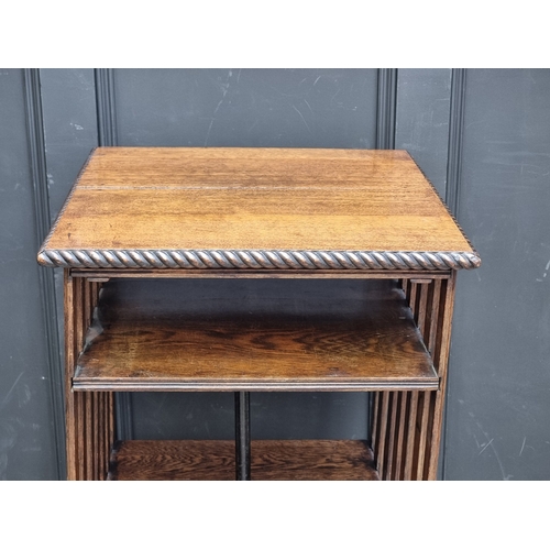 1027 - A 1920s oak revolving bookcase, 51cm wide, (formerly with additional drop leaf).