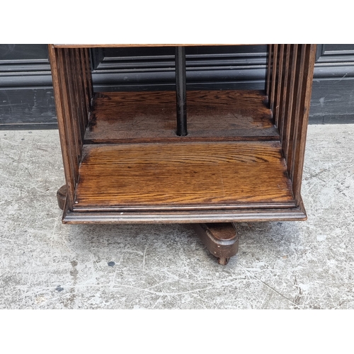 1027 - A 1920s oak revolving bookcase, 51cm wide, (formerly with additional drop leaf).