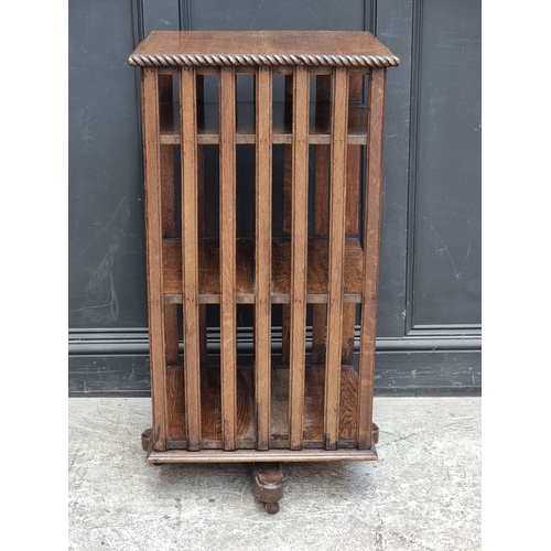 1027 - A 1920s oak revolving bookcase, 51cm wide, (formerly with additional drop leaf).