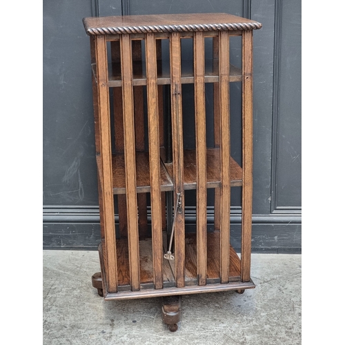 1027 - A 1920s oak revolving bookcase, 51cm wide, (formerly with additional drop leaf).