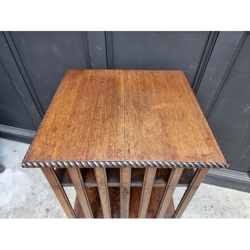 1027 - A 1920s oak revolving bookcase, 51cm wide, (formerly with additional drop leaf).