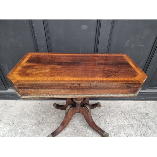 1037 - A Regency rosewood, faux grained and satinwood crossbanded pedestal card table, with brass mounts, 9... 