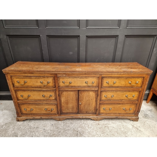 1051 - A George III oak, walnut crossbanded and line inlaid dresser base, 187cm wide.