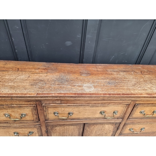 1051 - A George III oak, walnut crossbanded and line inlaid dresser base, 187cm wide.