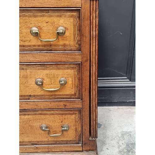1051 - A George III oak, walnut crossbanded and line inlaid dresser base, 187cm wide.